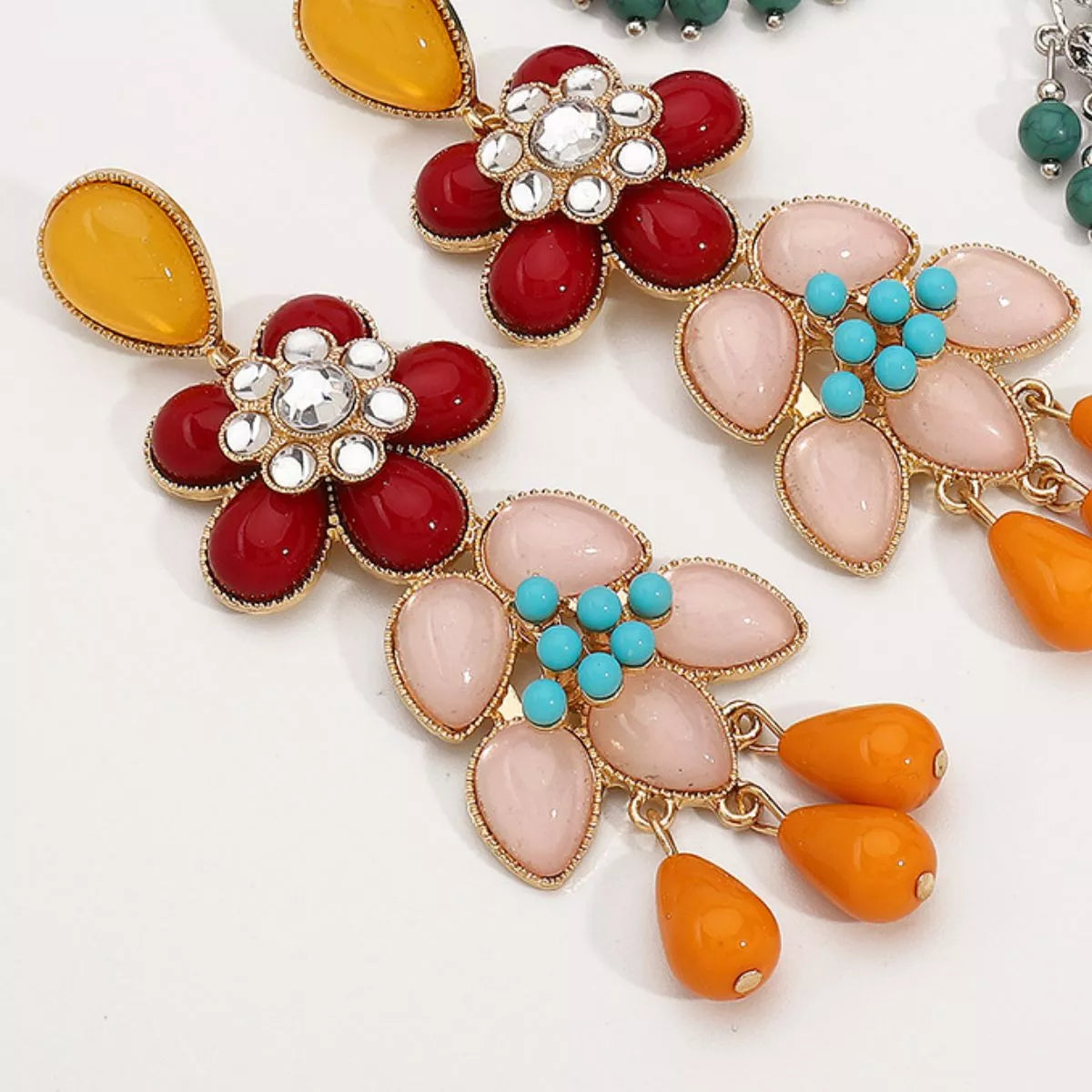 Flower dangle earrings by Trendsi featuring gold-tone metal and floral design, showcasing elegant jewelry with hanging floral accents.