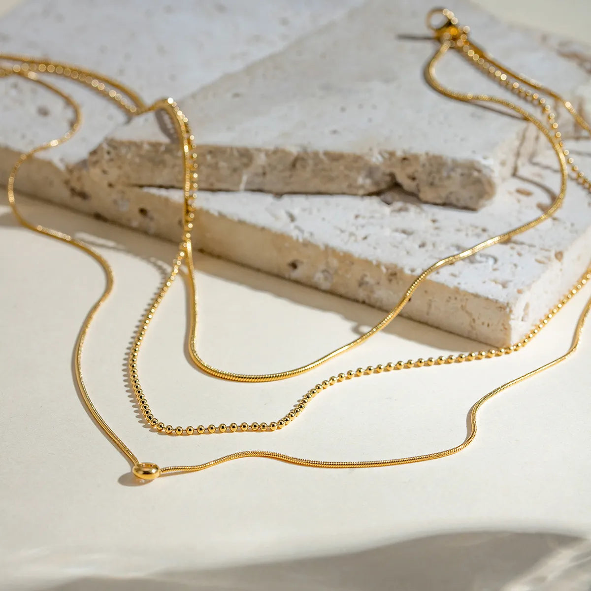 18K gold-plated layered necklace with delicate chain and pendant, showcasing trendy jewelry design and fine craftsmanship.