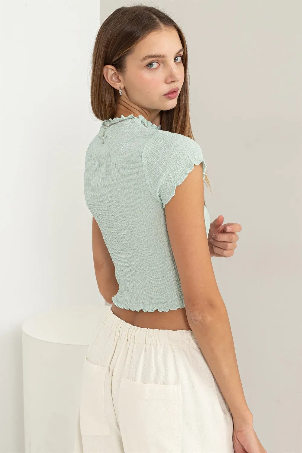 HYFVE lettuce hem crop top from Trendsi, featuring a stylish cropped design with lettuce-edged hem, perfect for casual outfits.