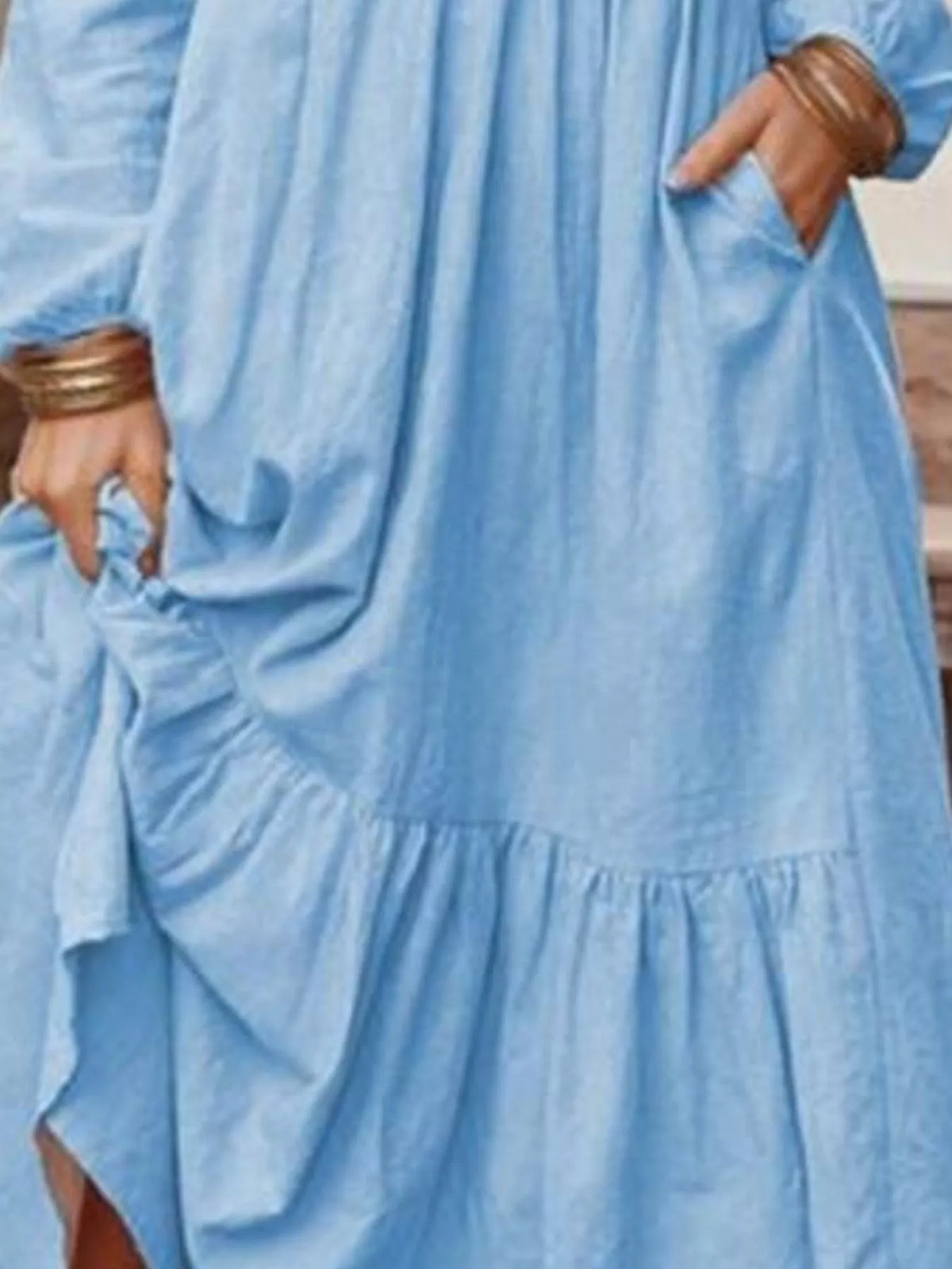 Plus size v-neck long sleeve tiered maxi dress with pockets by Trendsi, featuring a full-length design and flowing fabric.