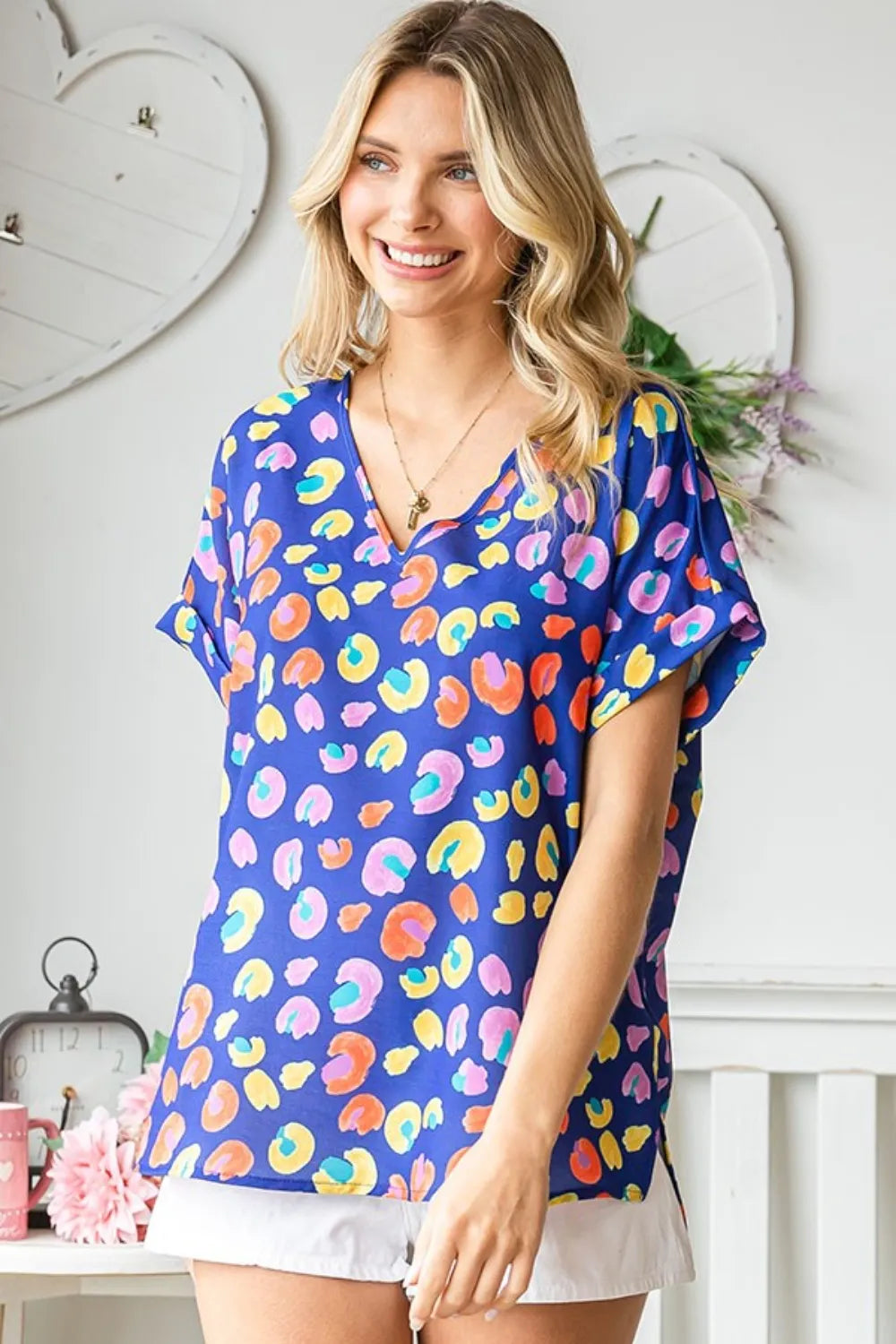 Printed V-neck short sleeve blouse by Trendsi featuring a floral design and lightweight fabric, perfect for casual or office wear.