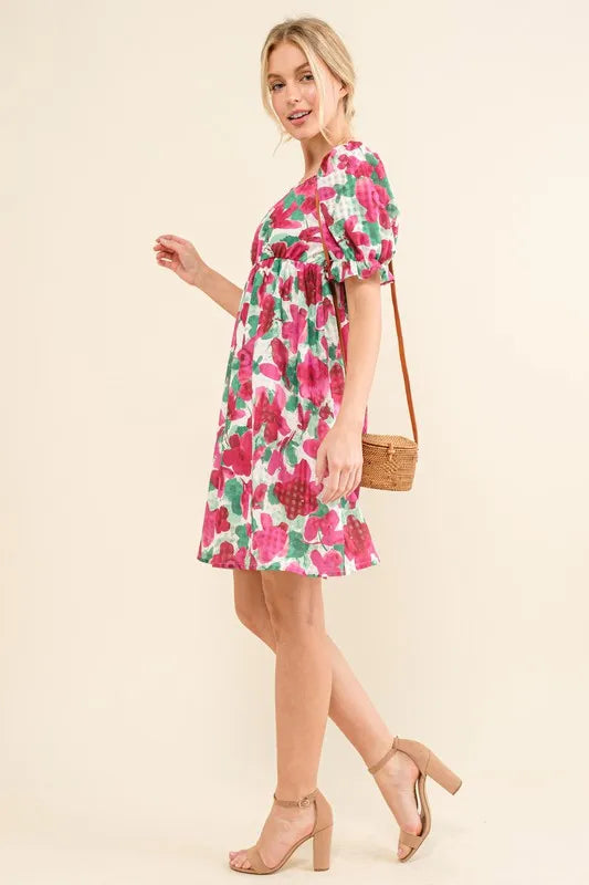 Smocked floral ruffle mini dress with short sleeves from And The Why by Trendsi, featuring a feminine, lightweight design.