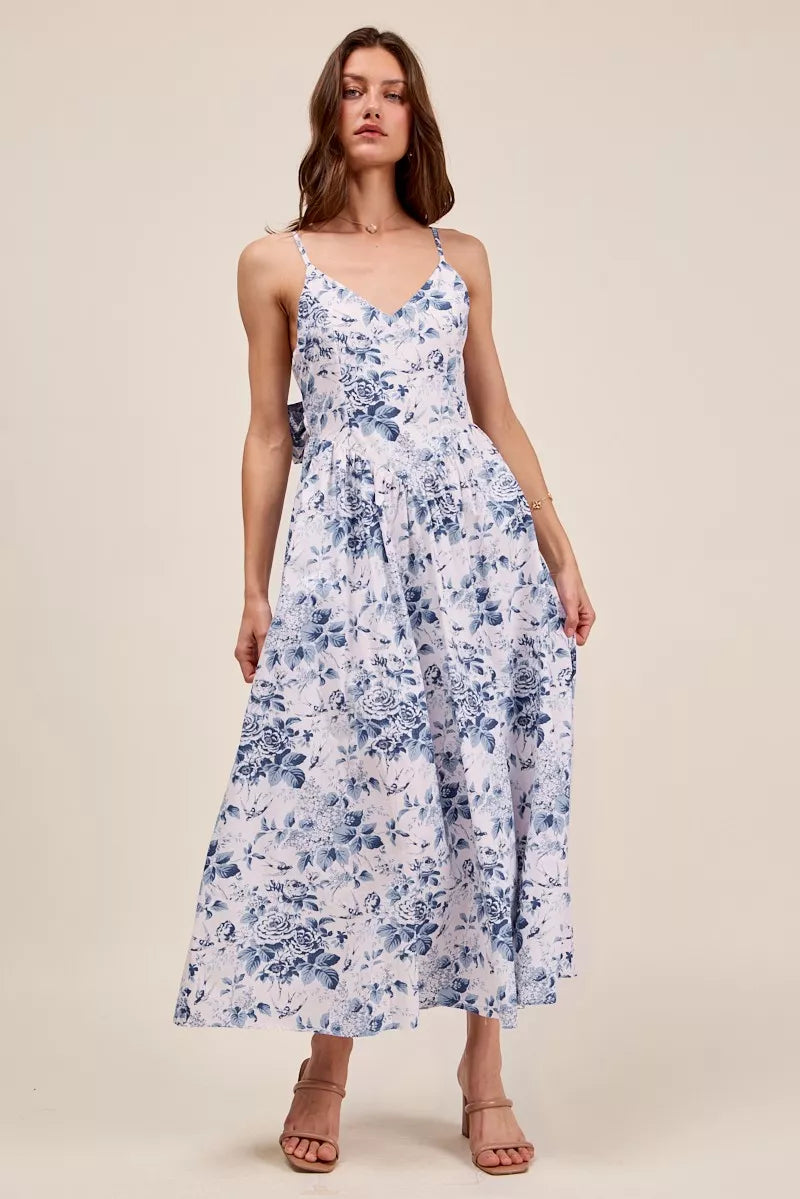 Floral woven V-neck dress with back ribbon tie from Trendsi, featuring a stylish design and feminine floral pattern.