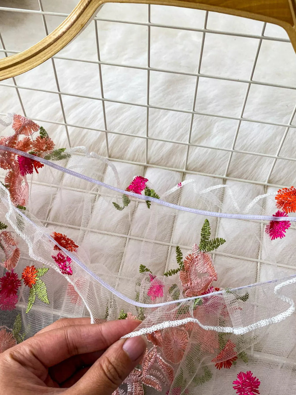 Floral embroidered mesh off-shoulder top by Trendsi featuring delicate embroidery and lightweight, sheer fabric with a stylish off-shoulder design.