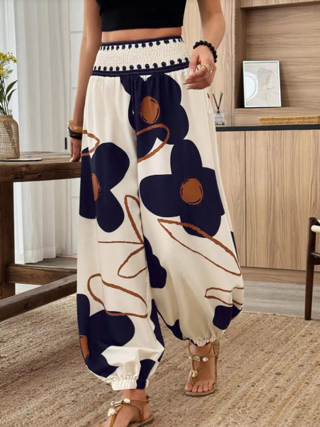 Floral print wide-leg pants from Trendsi featuring a relaxed fit and vibrant flower patterns on lightweight fabric.