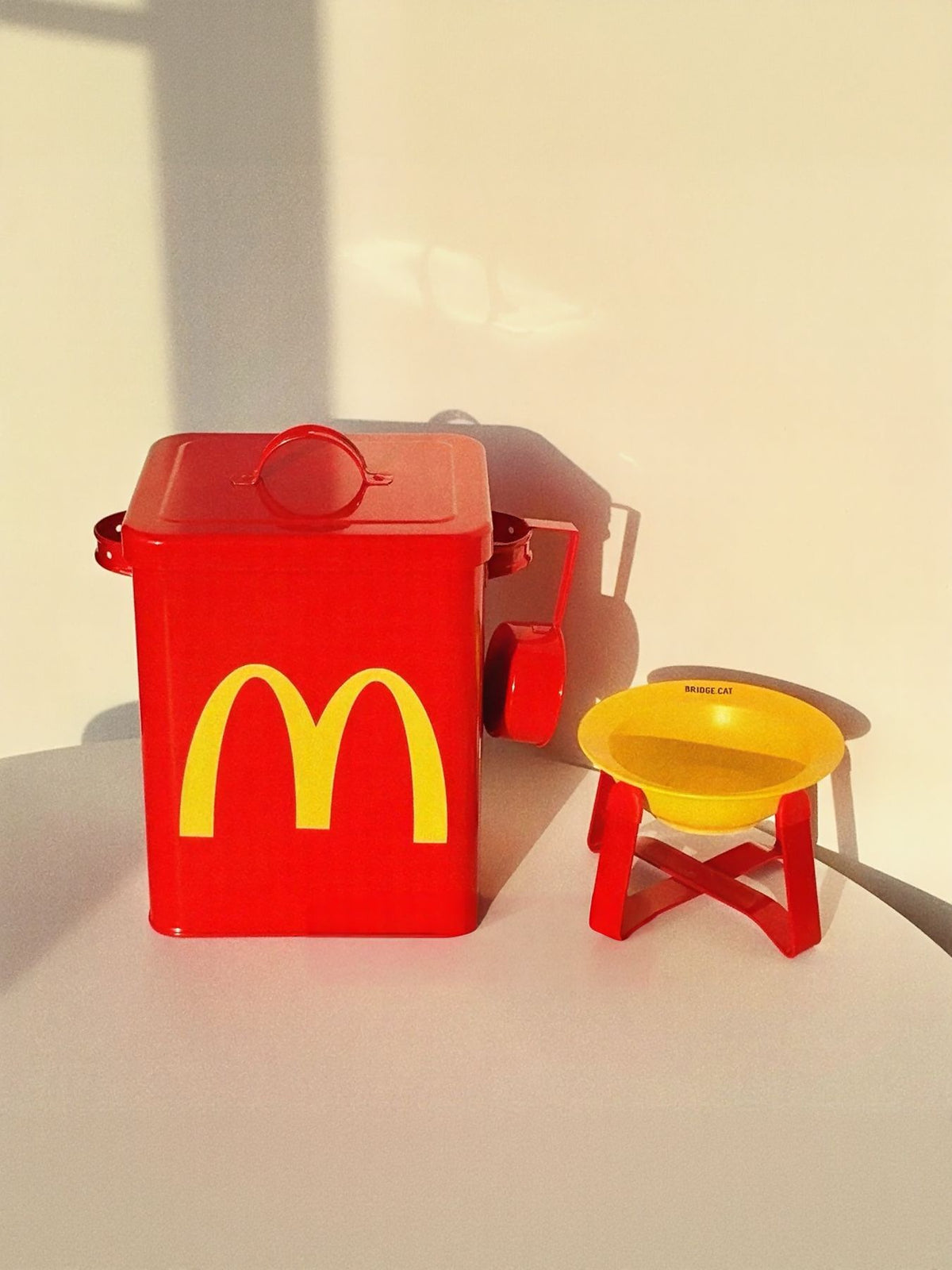 Trendsi pet food storage container styled like McDonald's packaging, with a clear lid and colorful branding for storing pet food.