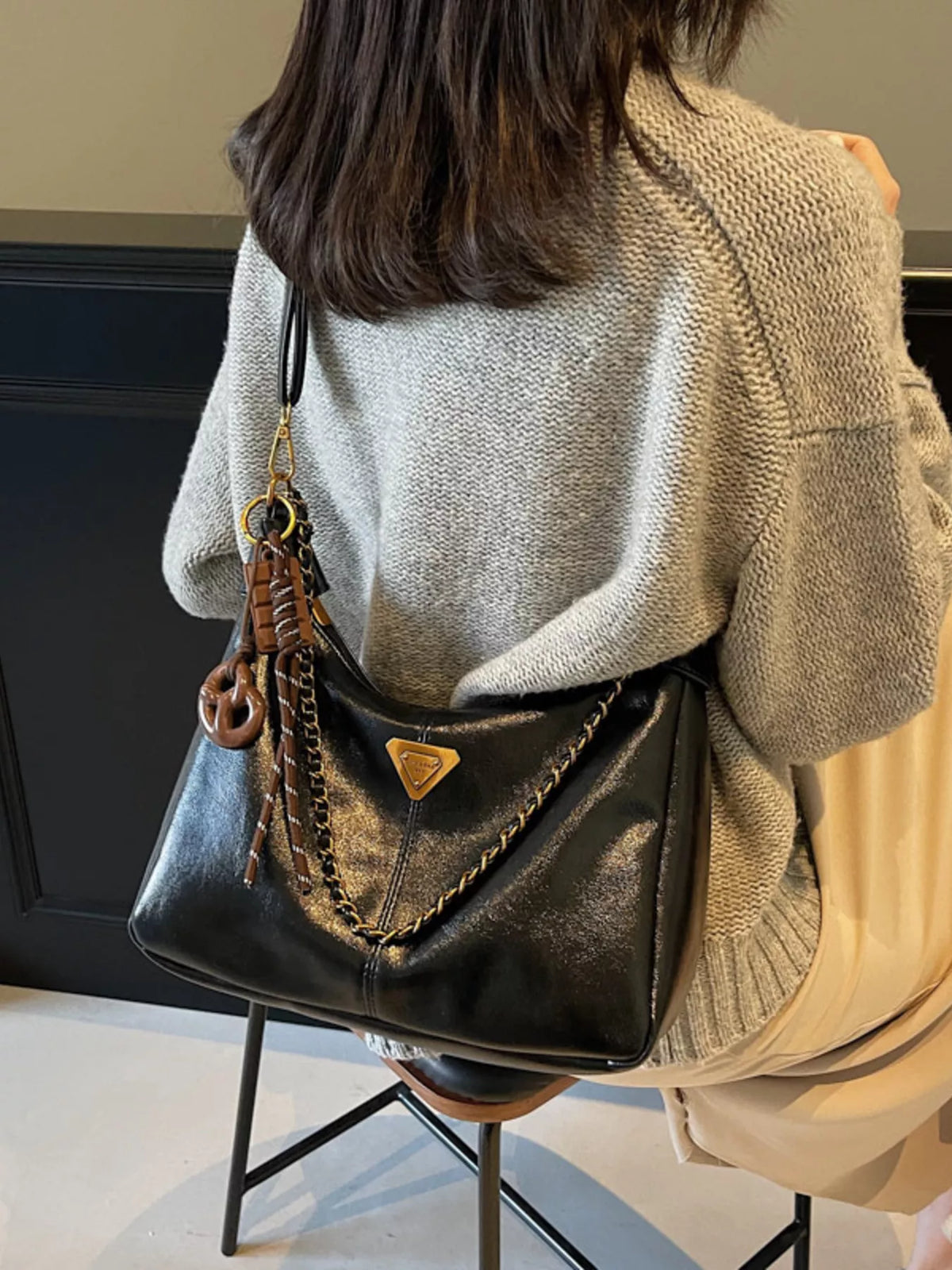 Chain detail crossbody bag with sleek design and adjustable strap, featuring trendy hardware and spacious interior.