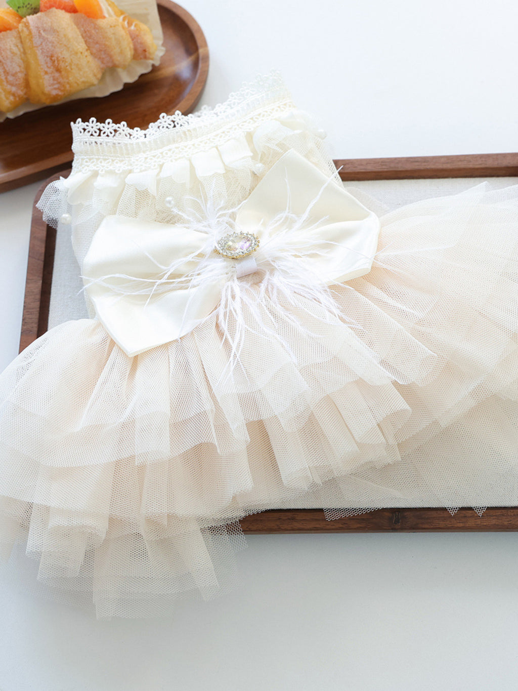 Cute pet dress with tulle ruffles and bow detail, perfect for small dogs or cats, by Trendsi.
