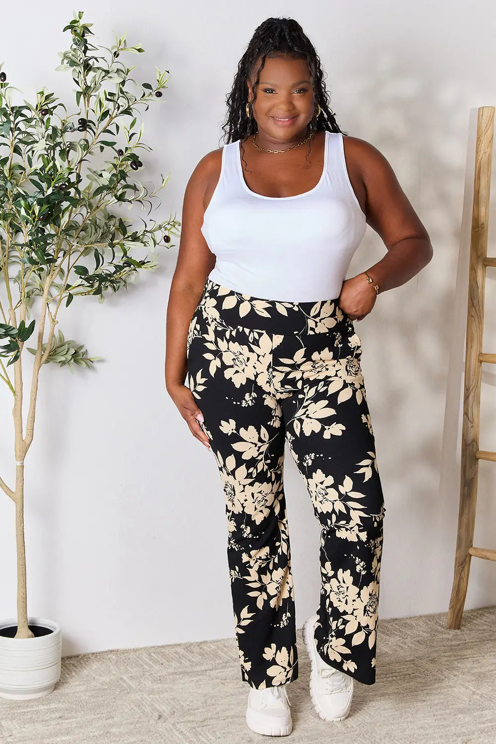 Heimish full size high waist floral flare pants by Trendsi, showcasing vibrant floral pattern and wide-leg silhouette.