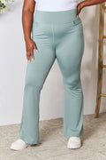 Heimish full size wide waistband sports pants in plus size, featuring a comfortable fit and stylish design, shown on a model.