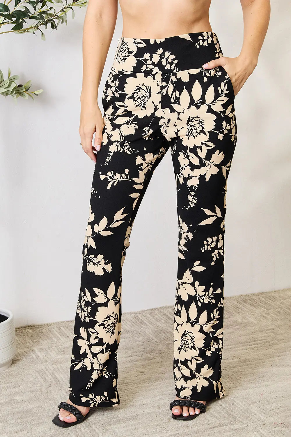 Plus size Heimish high waist floral flare pants from Trendsi, featuring a full-length design with a vibrant floral pattern.