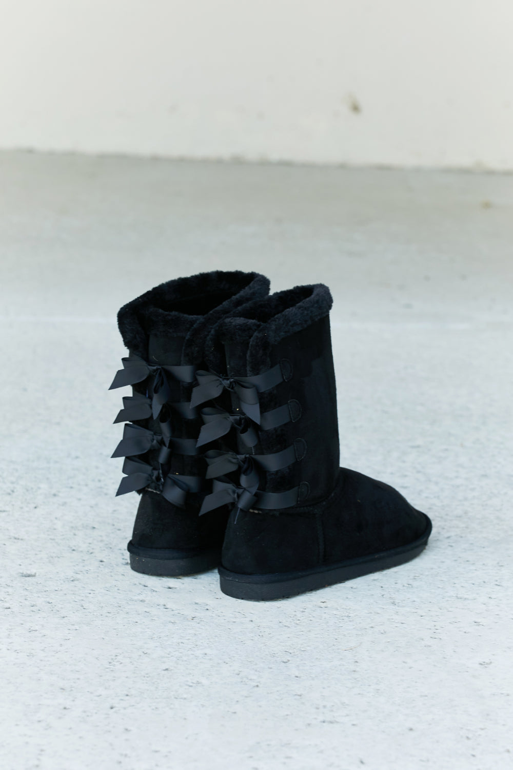Forever Link faux suede leather snow boots with bow detail, featuring a sturdy sole and winter-ready design.
