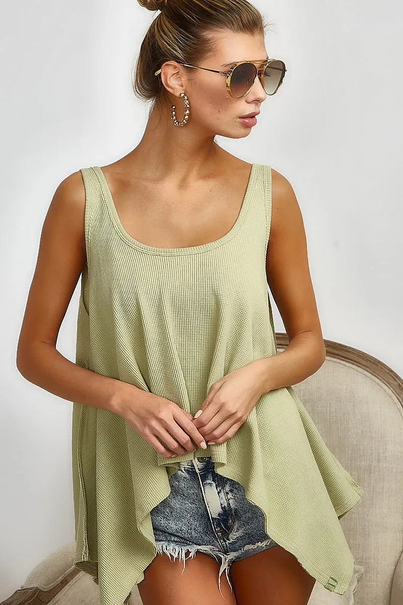 Trendsi BiBi high and low flare knit tank top in beige, featuring a sleeveless design with a fitted bodice and flared hem.