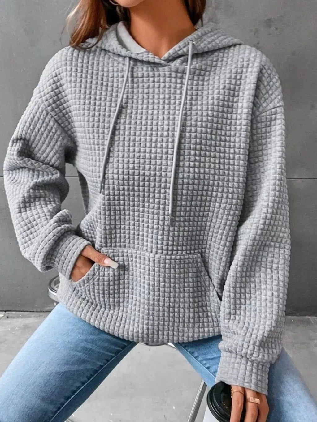 Plus size textured kangaroo pocket hoodie by Trendsi, showing the front view with a cozy, full-size design and ribbed cuffs.