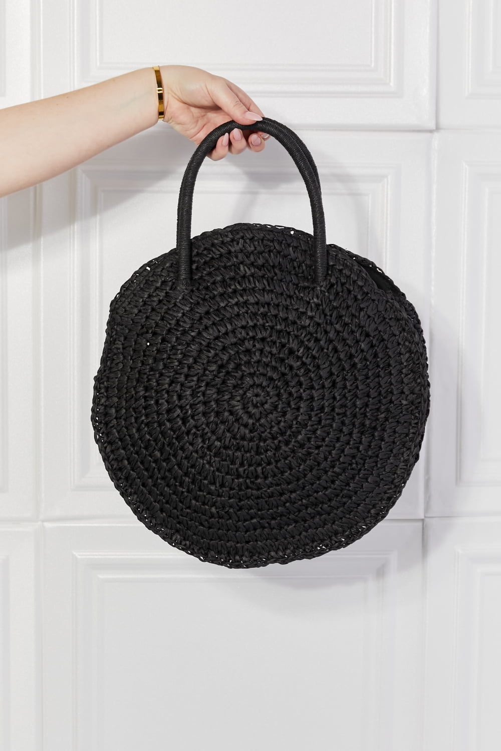 Justin Taylor Beach Date Straw Rattan Handbag in black with woven straw design and black leather accents.