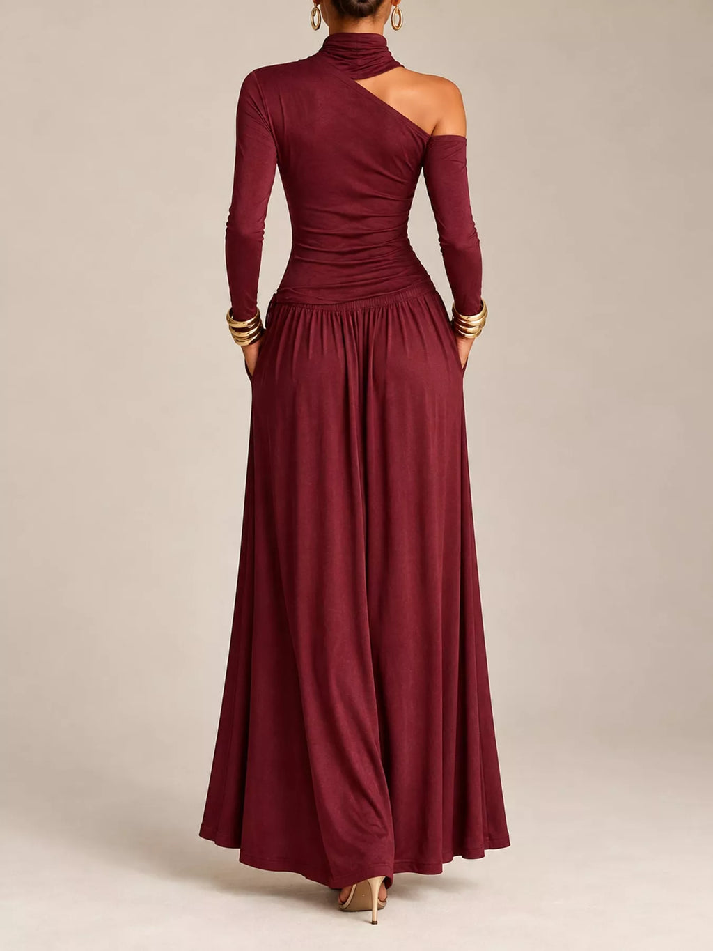 Asymmetric cutout long sleeve maxi dress by Trendsi featuring a stylish design and flowing fabric, shown in a full-length view.