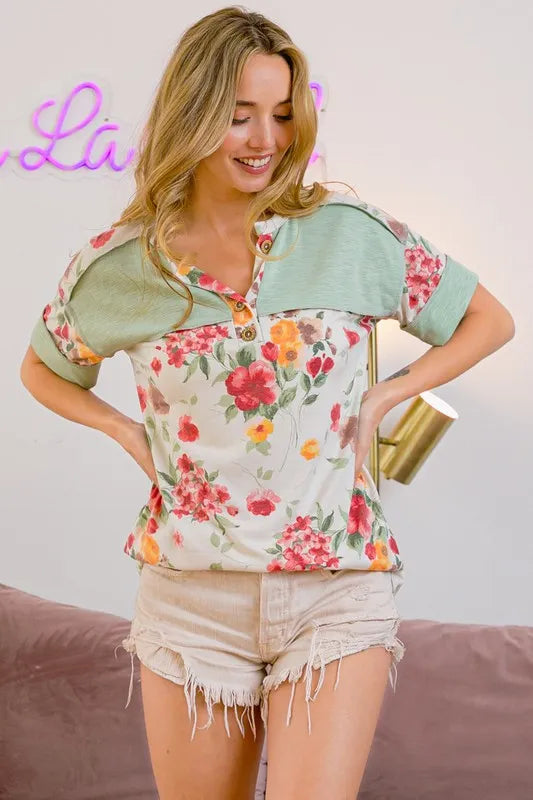 BiBi Floral Button Detail Round Neck Short Sleeve Terry T-Shirt by Trendsi, featuring floral accents and casual short sleeve style.