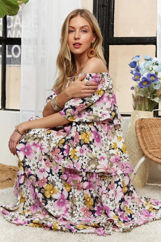 Layered floral off-shoulder maxi dress in mauve by Trendsi featuring short sleeves and a flowing, elegant design.