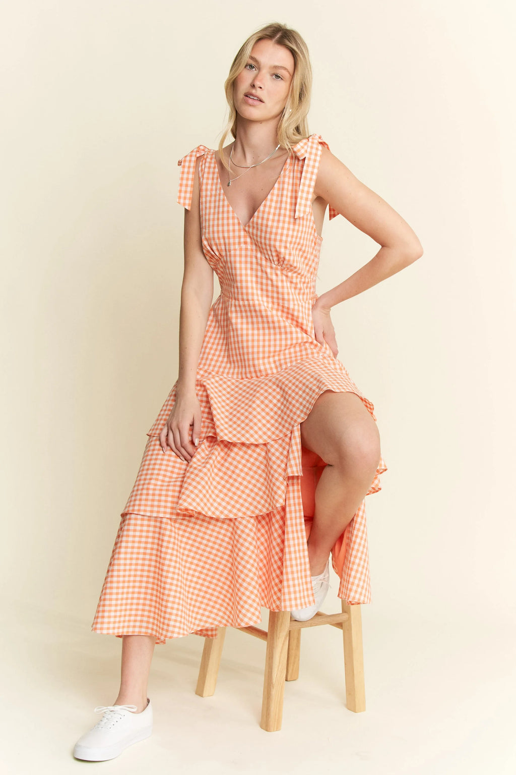 Jade By Jane sleeveless gingham print tiered midi dress from Trendsi, featuring a stylish tiered design and classic gingham pattern.
