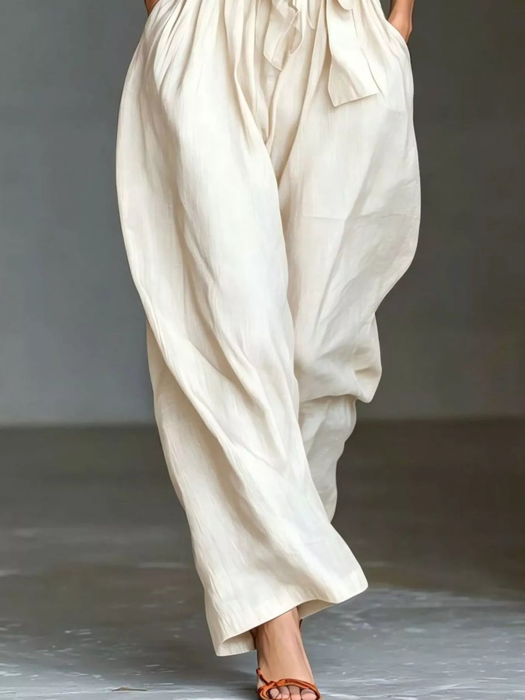 Halter neck wide-leg jumpsuit with waist-tie detail, stylish and comfortable, worn by a model showcasing trendy fashion.