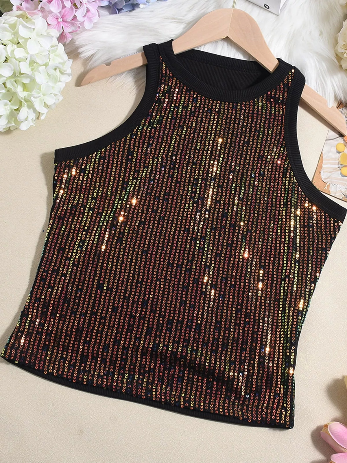 Sequin round neck tank top from Trendsi featuring shiny sequins, sleeveless design, and a casual fit for stylish summer wear.