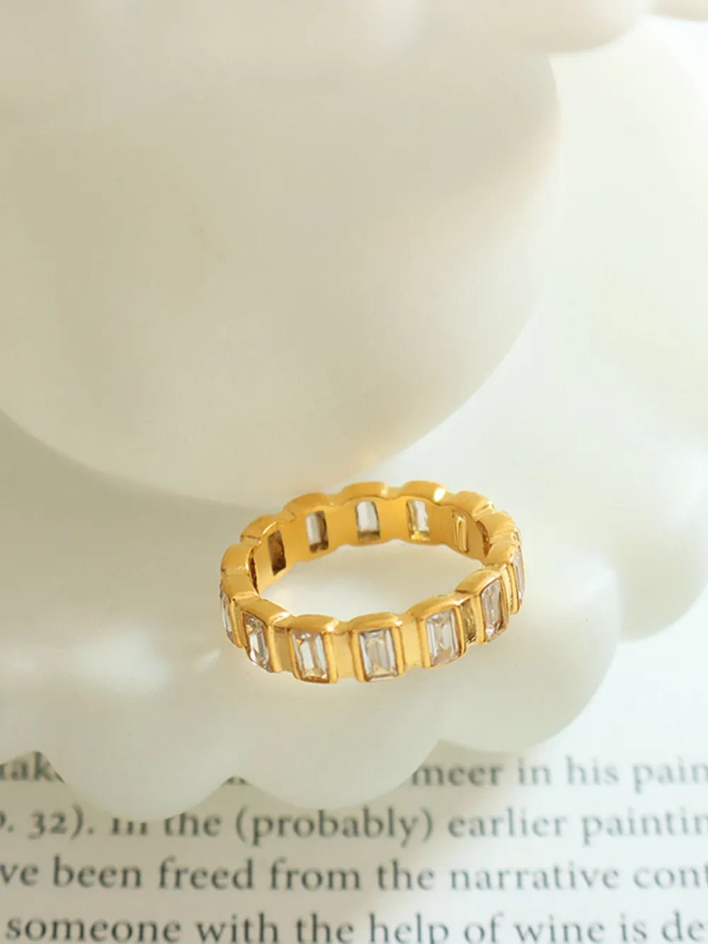 Titanium steel ring with inlaid zircon stones, featuring a sleek design and polished finish, perfect for stylish jewelry wear.