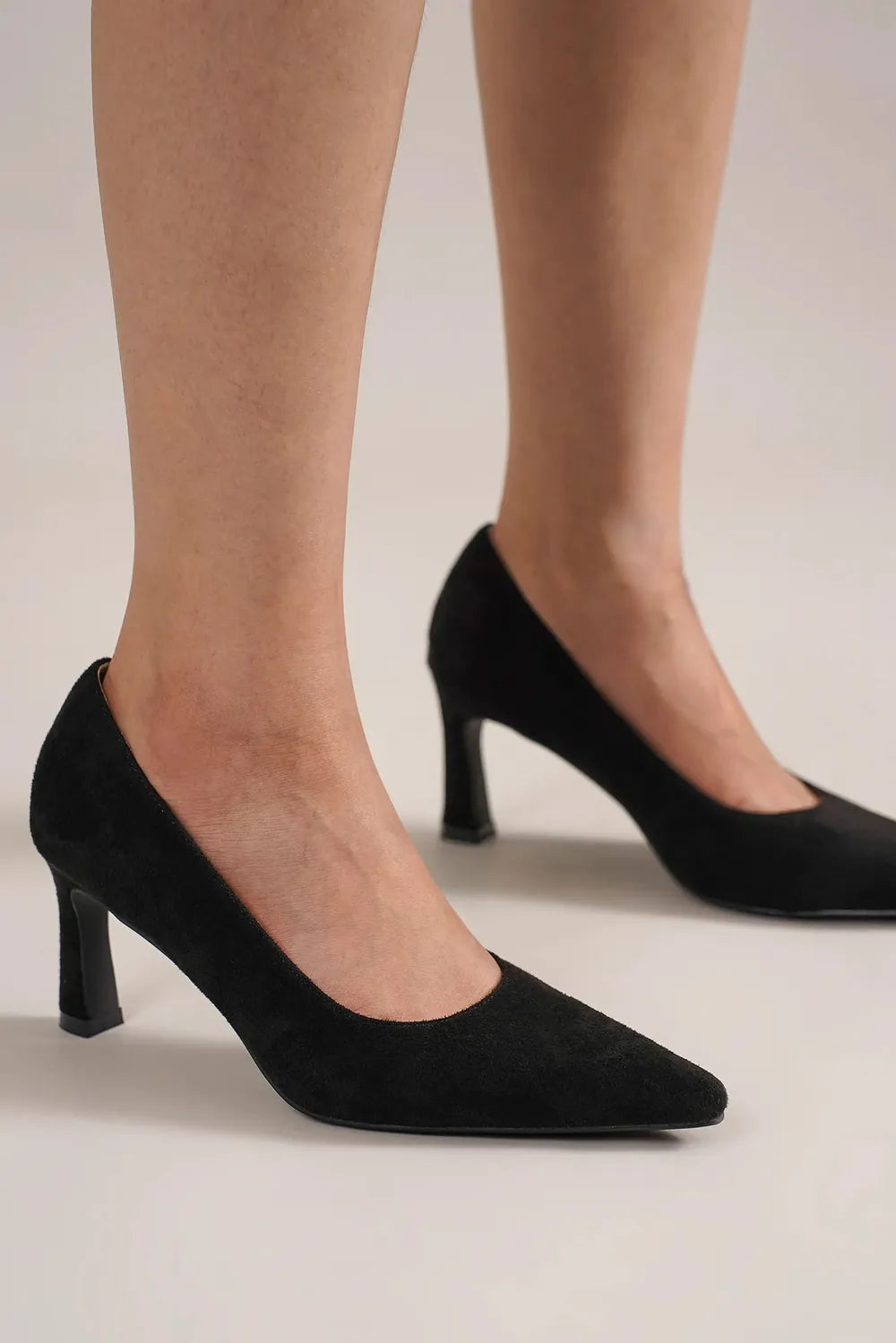 Beast Fashion faux suede point toe pumps with stiletto heels, stylish women's footwear by Trendsi, shown from a side angle.