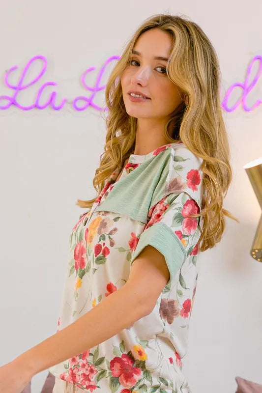 Trendsi BiBi floral short sleeve terry T-shirt with round neck and button details, featuring a colorful floral pattern on soft fabric.
