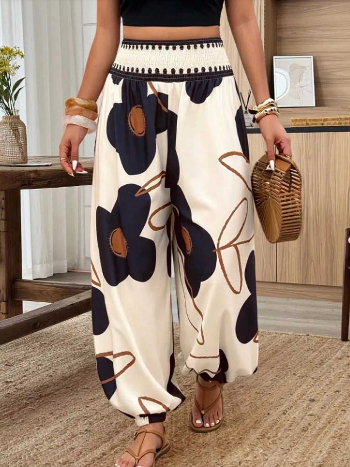 Floral print wide-leg pants from Trendsi featuring vibrant flower patterns and flowing fabric, perfect for a stylish spring look.
