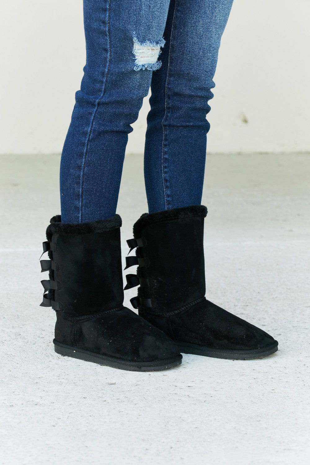Forever Link Bow Detail Faux Suede Leather Snow Boots by Trendsi featuring bow accents and durable winter-ready faux suede material.