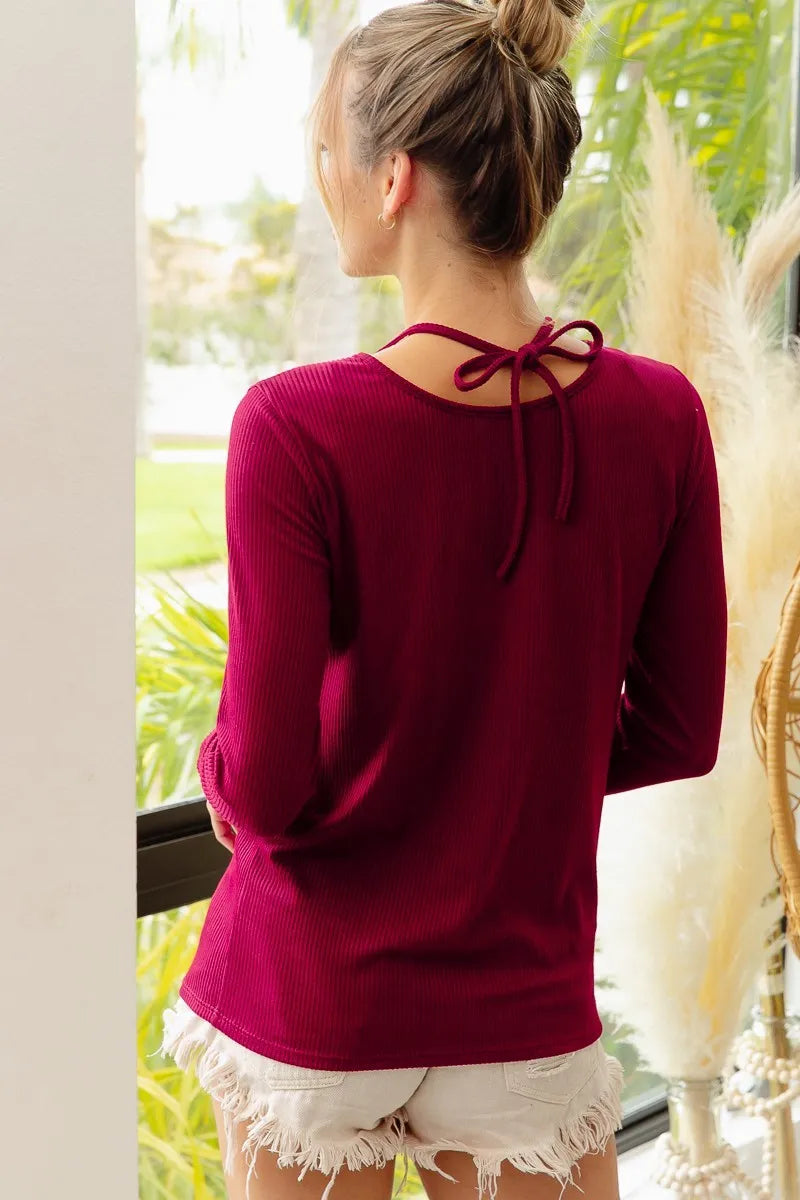 Trendsi BiBi rib knit top with cut-out details and tied neckline, featuring a fitted design and stylish knit texture.