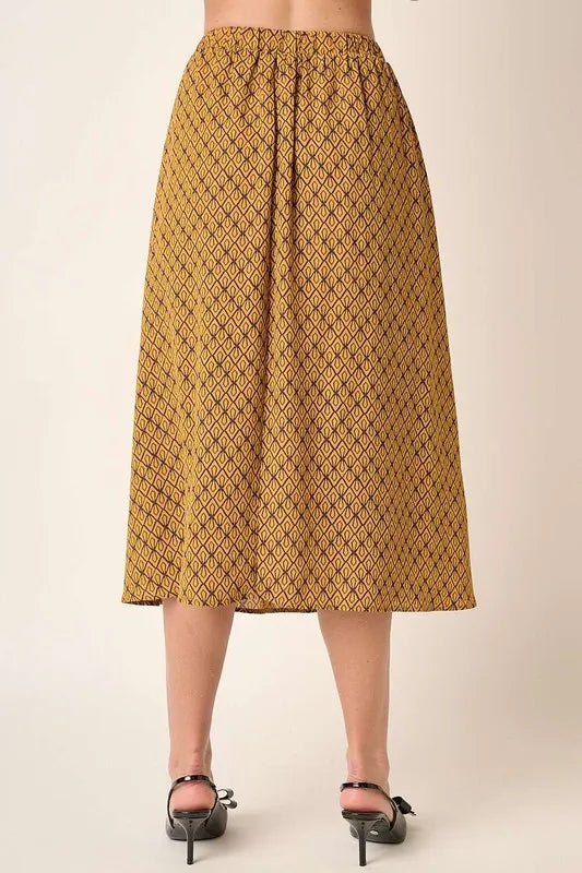 Printed midi skirt from Mittoshop by Trendsi, featuring a colorful floral pattern and flowy fabric.