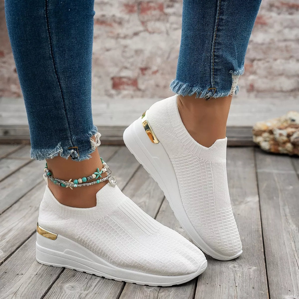 Mesh round toe wedge athletic shoes by Trendsi featuring breathable mesh material and sporty design.