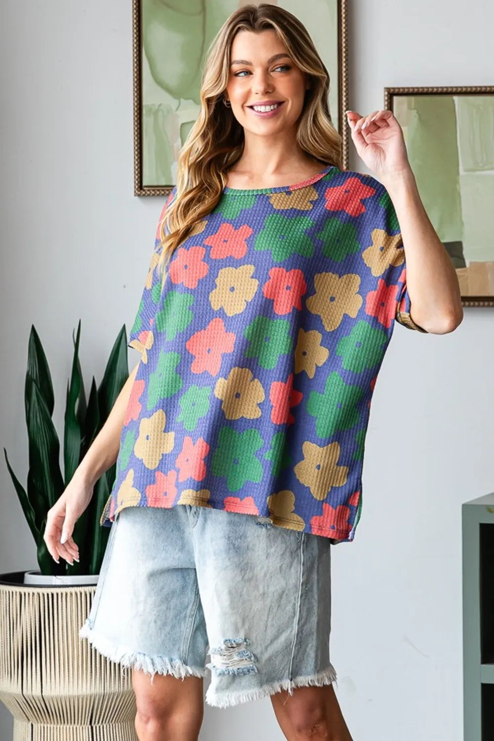 HopeLy floral round neck t-shirt by Trendsi featuring a full size fit, floral pattern, and side slit detail.