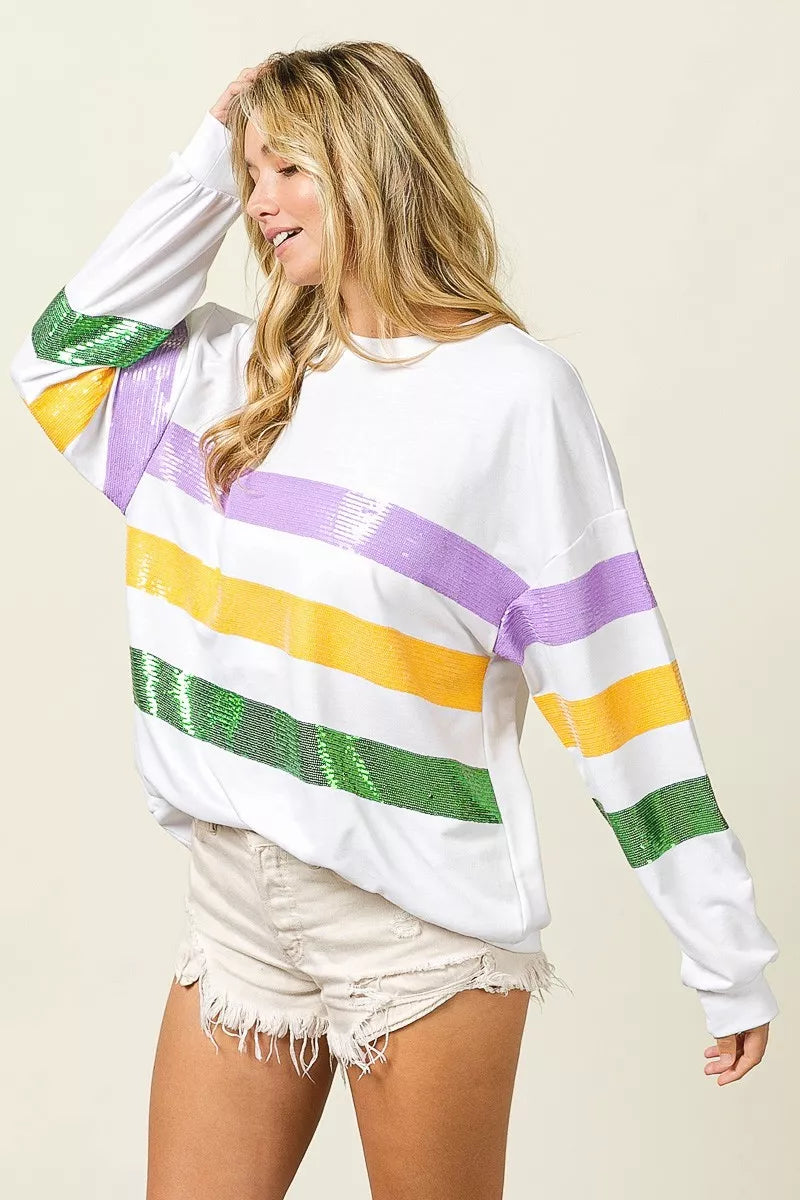Sequin Mardi Gras striped round neck sweatshirt by Trendsi featuring colorful sequins and a comfortable fit.