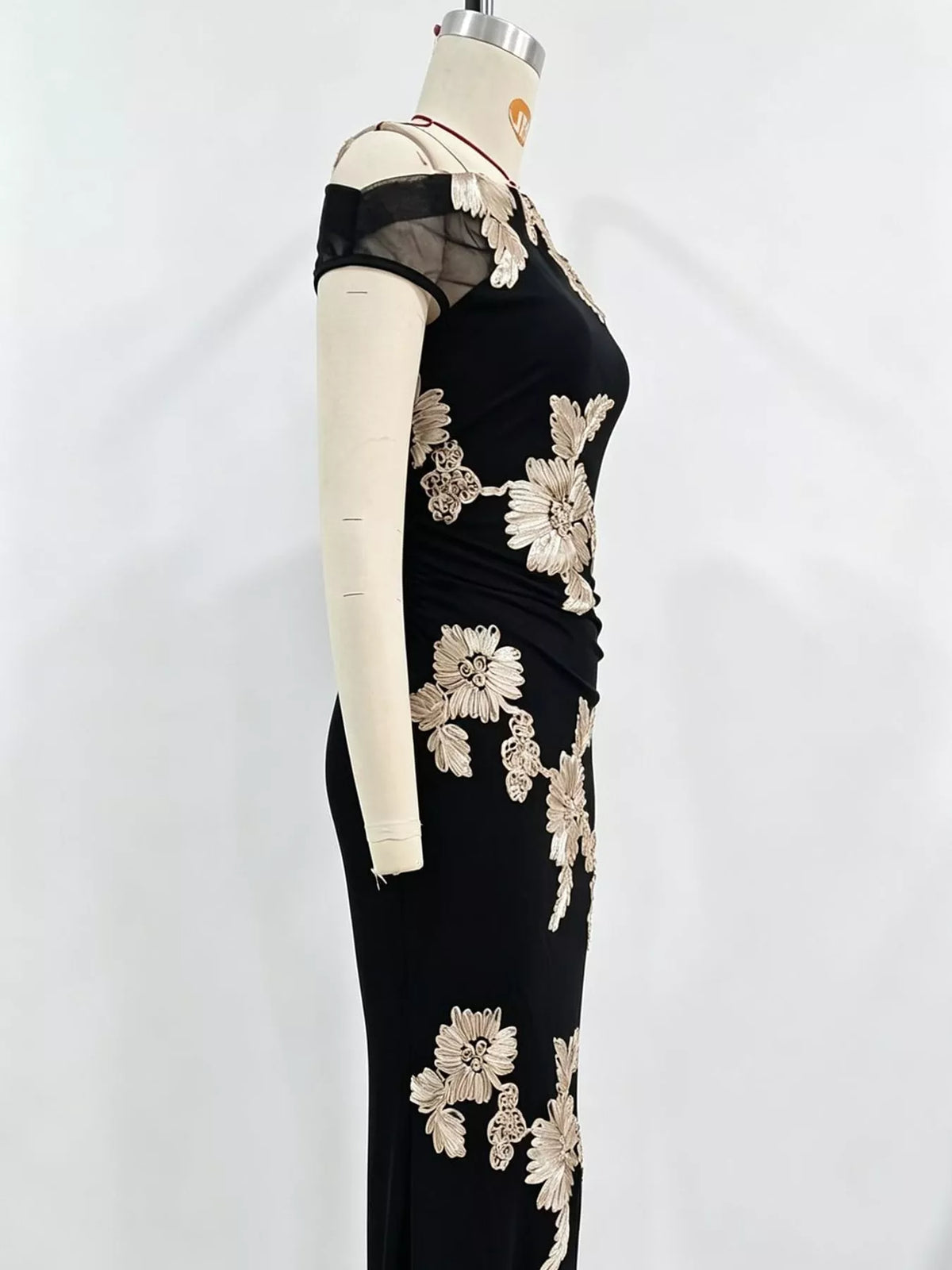 One-shoulder floral embroidered maxi dress by Trendsi featuring vibrant floral embroidery and flowing fabric.