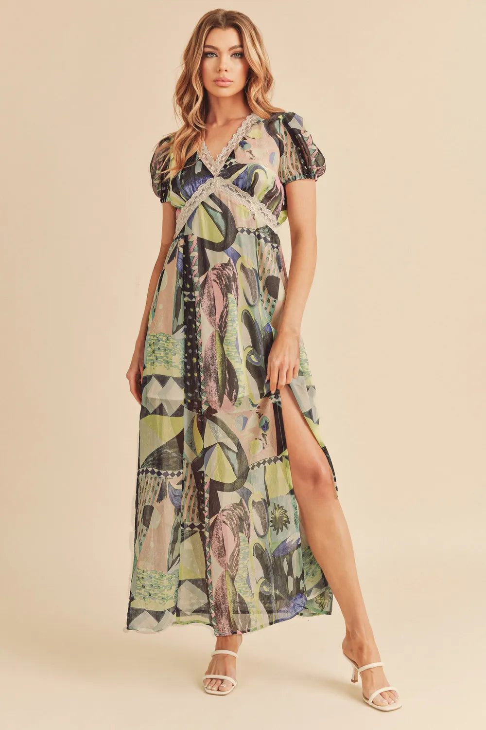 Aemi + Co geometric print maxi dress with lace detail, short sleeves, slit, and a stylish, flowing silhouette.