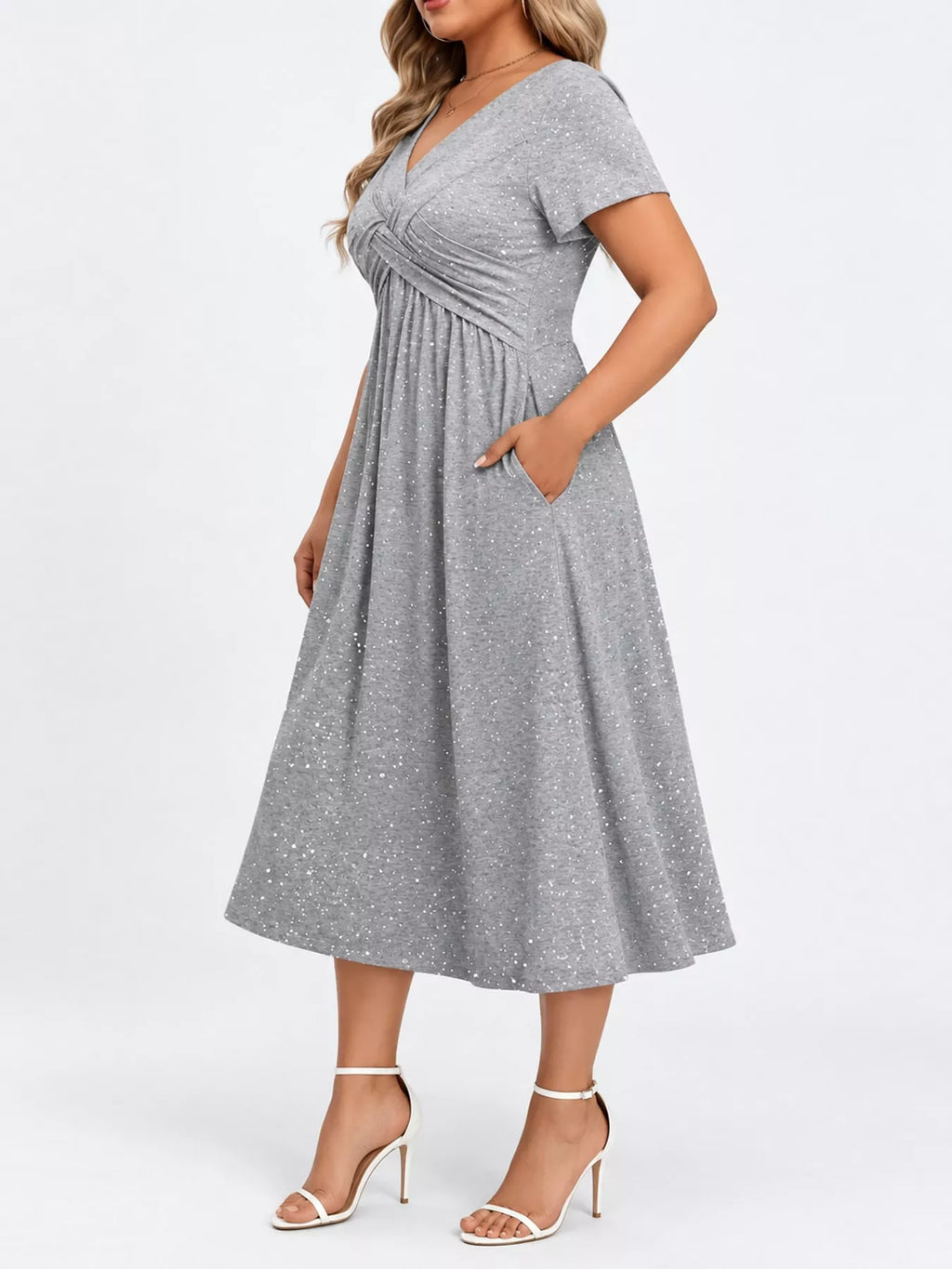 Plus size twisted front short sleeve midi dress with pockets by Trendsi, featuring a flattering design and comfortable fit.