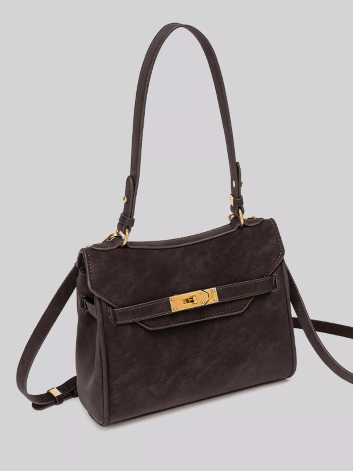 Gold-tone hardware crossbody bag with sleek design, featuring a compact silhouette and adjustable strap, perfect for stylish everyday use.