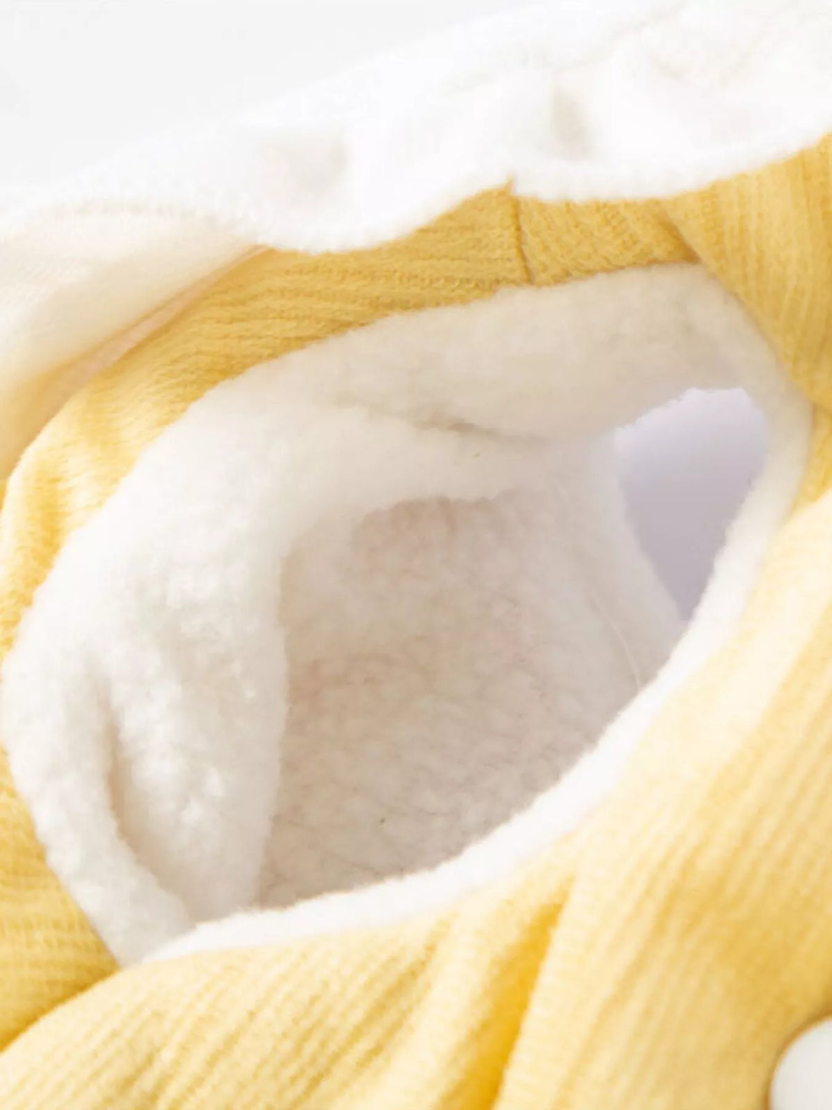 Button-down pet jumpsuit with ruffle collar from Trendsi, showing the stylish design and fabric details on a small dog.