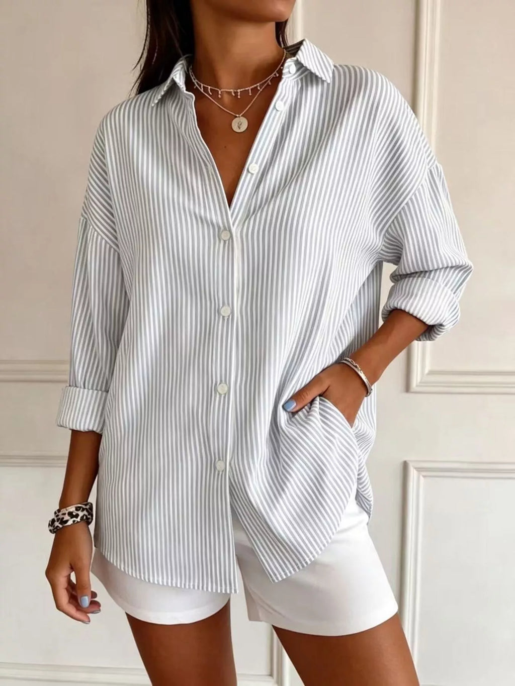 Plus size striped button-down long sleeve shirt by Trendsi, featuring a full-size fit and classic design, shown on a model.