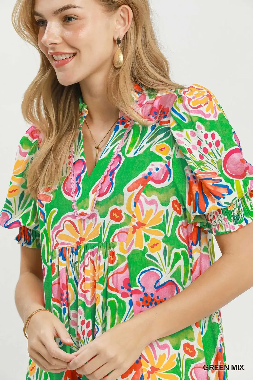 Umgee floral print puff sleeve tiered midi dress displayed on a model, showcasing its flowy silhouette and vibrant pattern.