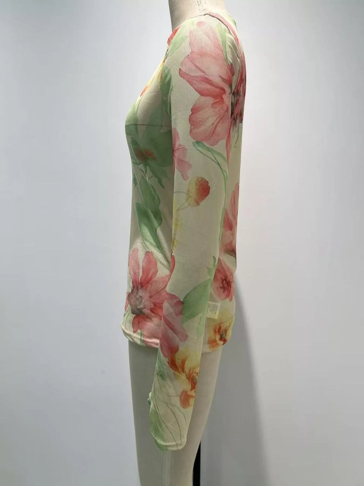Plus size floral print sheer mesh long sleeve T-shirt by Trendsi, showcasing a lightweight, breathable design with vibrant floral patterns.