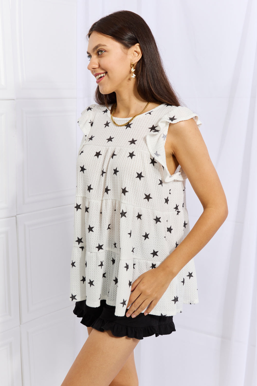 Heimish Shine Bright butterfly sleeve star print top from Trendsi, featuring a full-size design with colorful star patterns and butterfly sleeves.