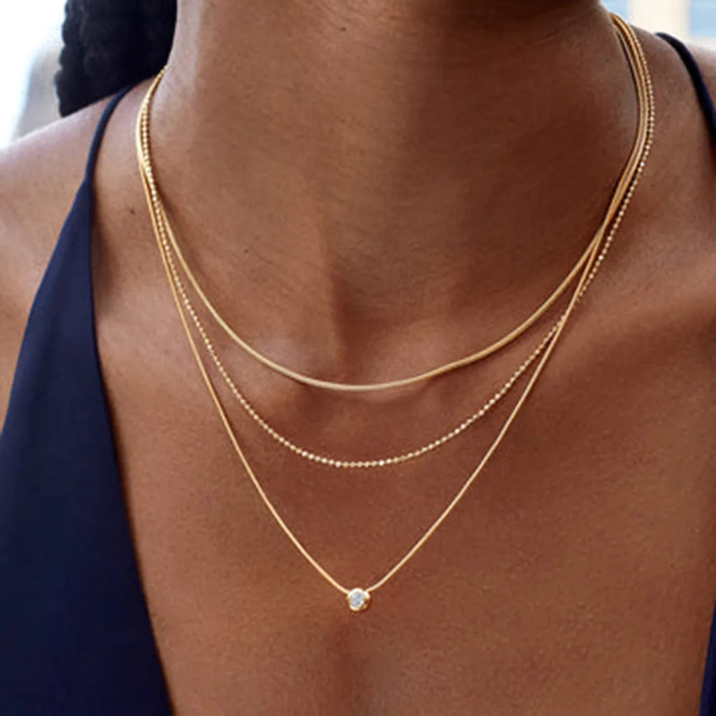 Gold-plated layered necklace with delicate chains and small pendant, trendy jewelry by Trendsi in 18K gold finish.