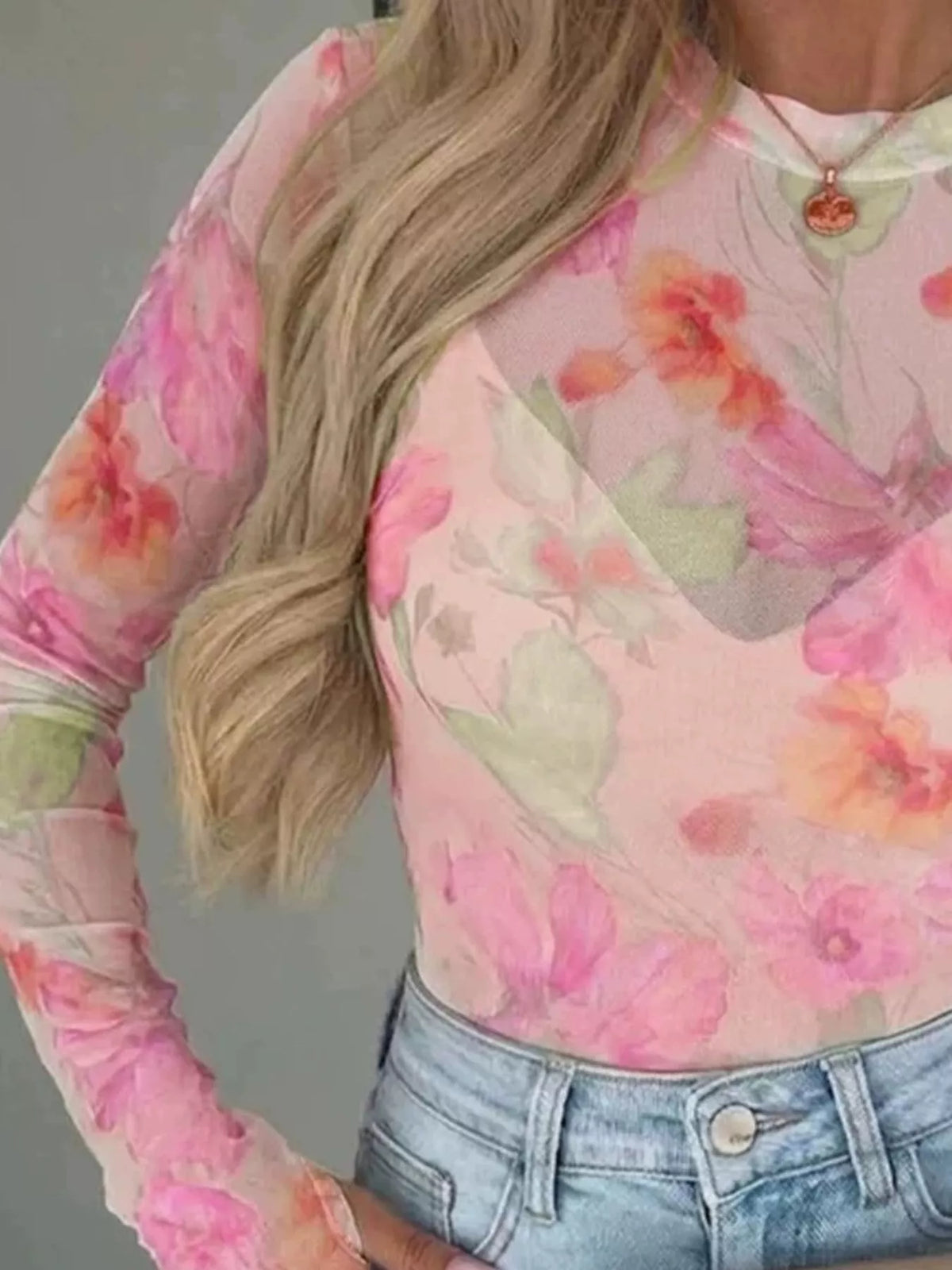 Plus size floral print sheer mesh long sleeve t-shirt by Trendsi, featuring a full-size floral pattern and lightweight, breathable fabric.