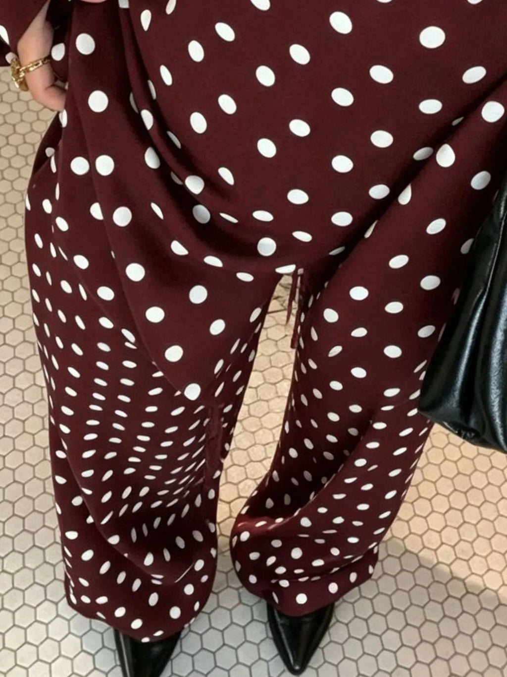 Polka dot boat neck top and pants set by Trendsi featuring a stylish, coordinated outfit with a boat neckline and polka dot pattern.
