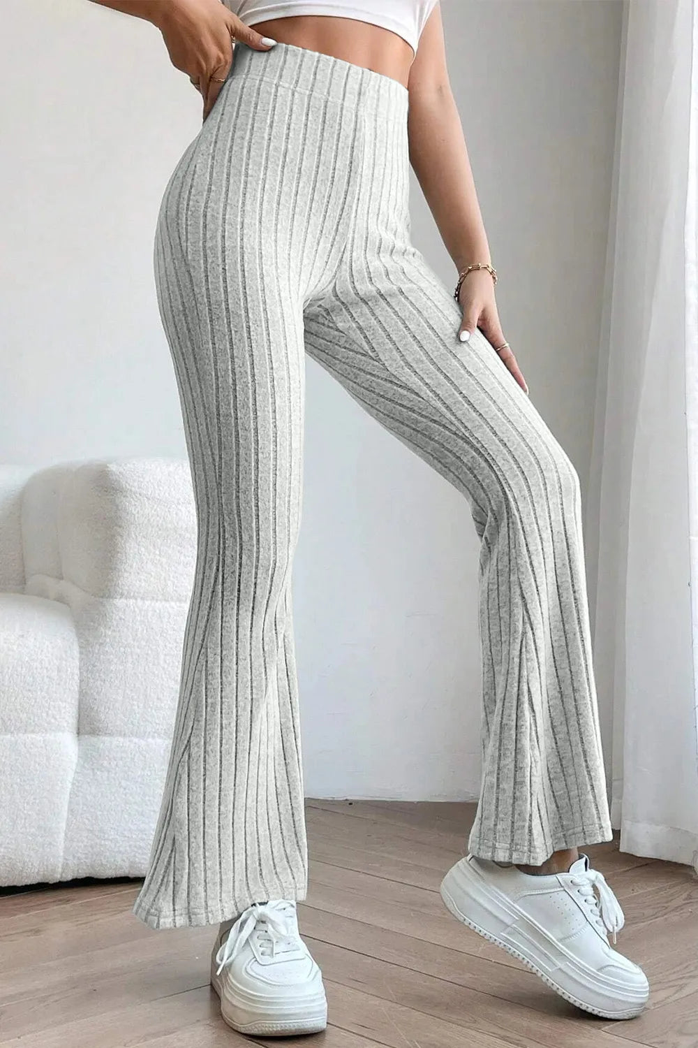 Full view of Trendsi Basic Bae Full Size Ribbed High Waist Flare Pants displayed on a hanger.