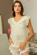 BiBi Floral Ruffled Armhole V-Neck Top by Trendsi featuring a v-neck, floral pattern, and ruffled armholes, displayed on a hanger.