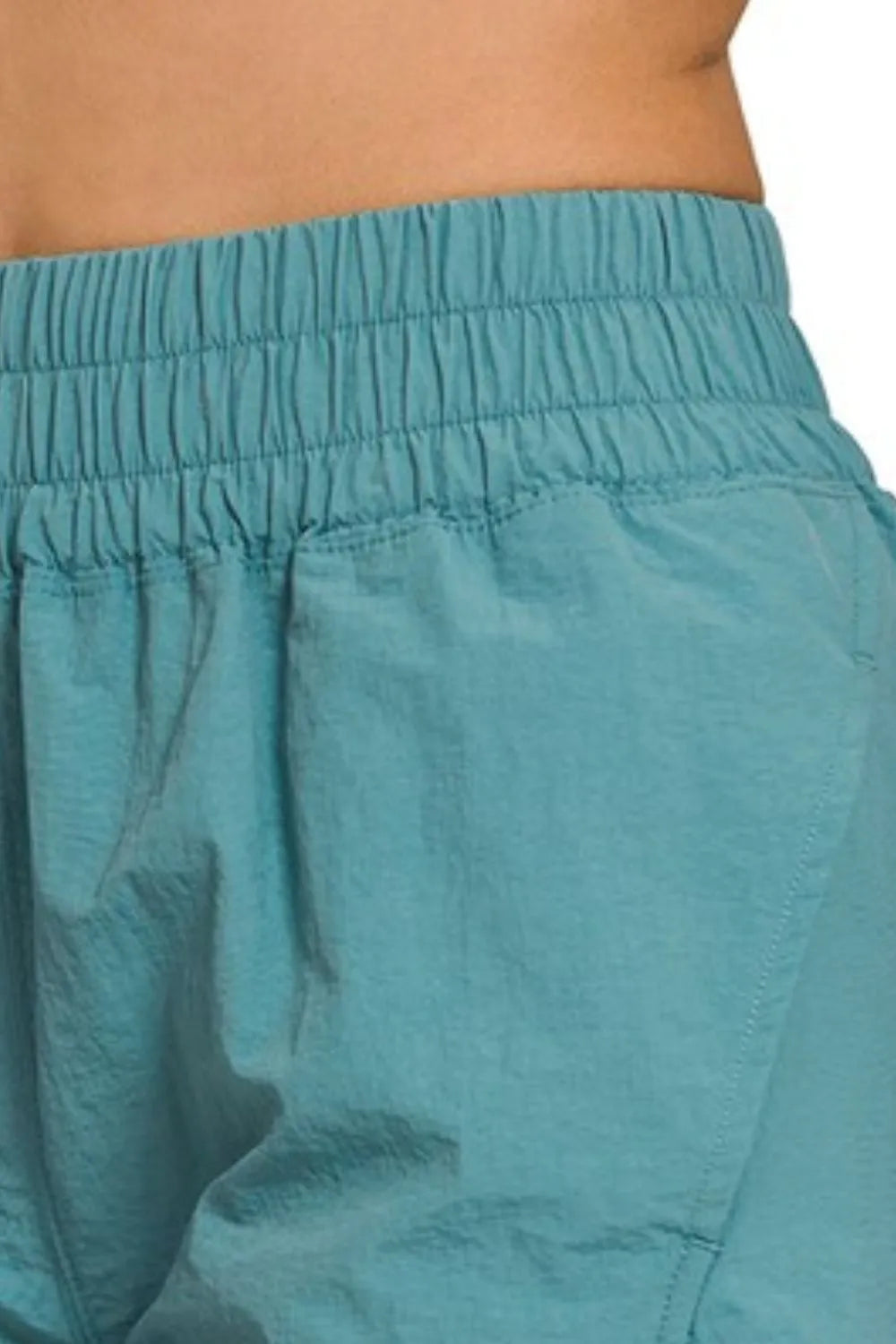 Zenana Trendsi windbreaker running shorts with smocked waistband, lightweight fabric, and athletic fit for activewear.